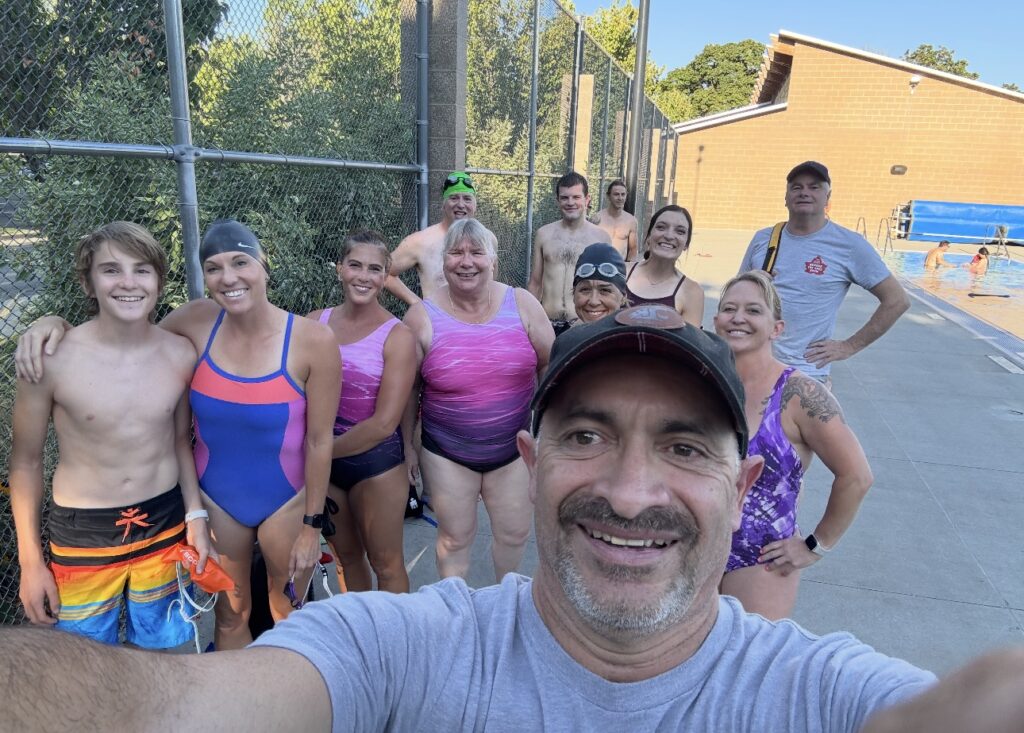 Victor smiling with group of female runners before workout